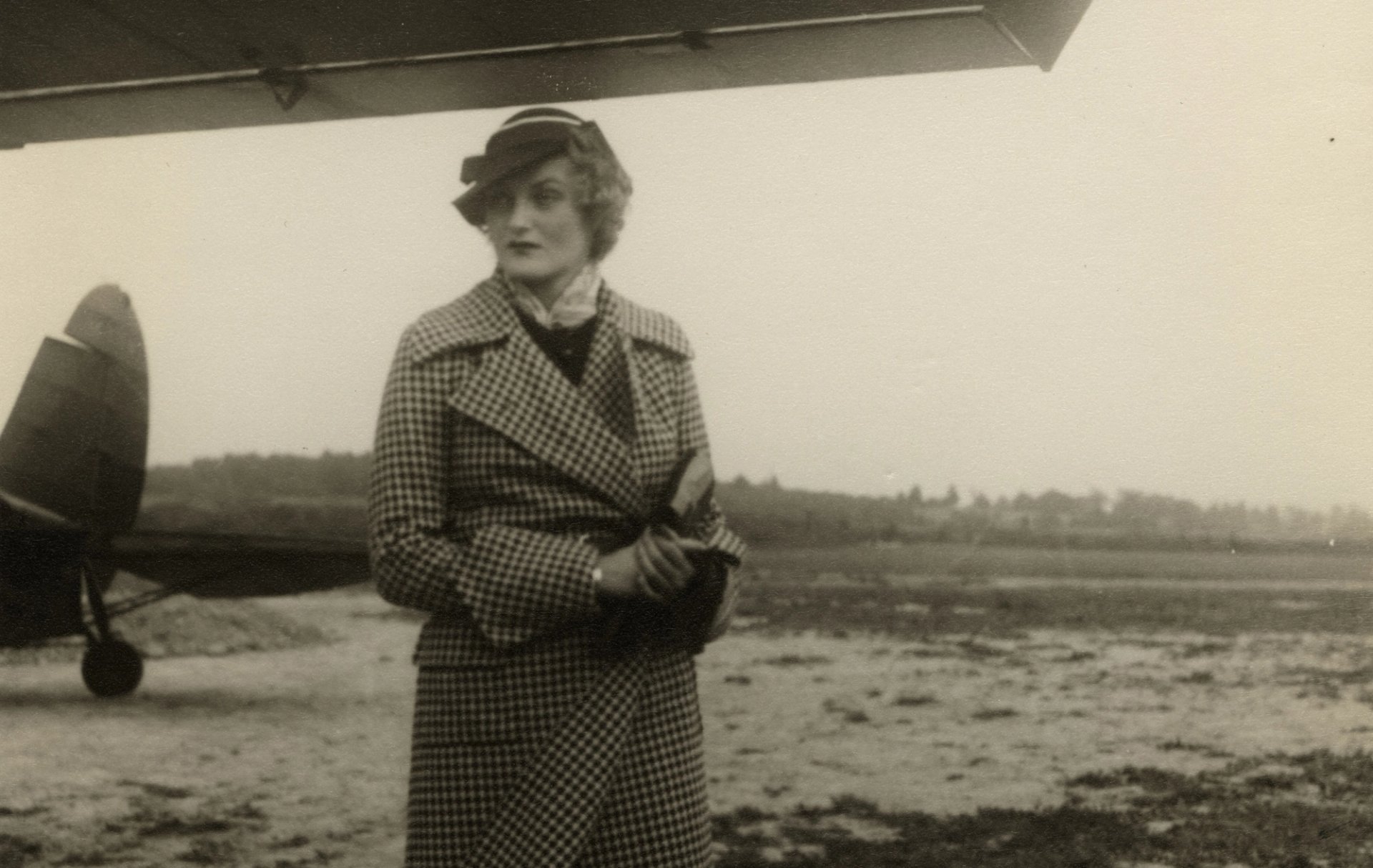 Doris Duke standing in front of a plane