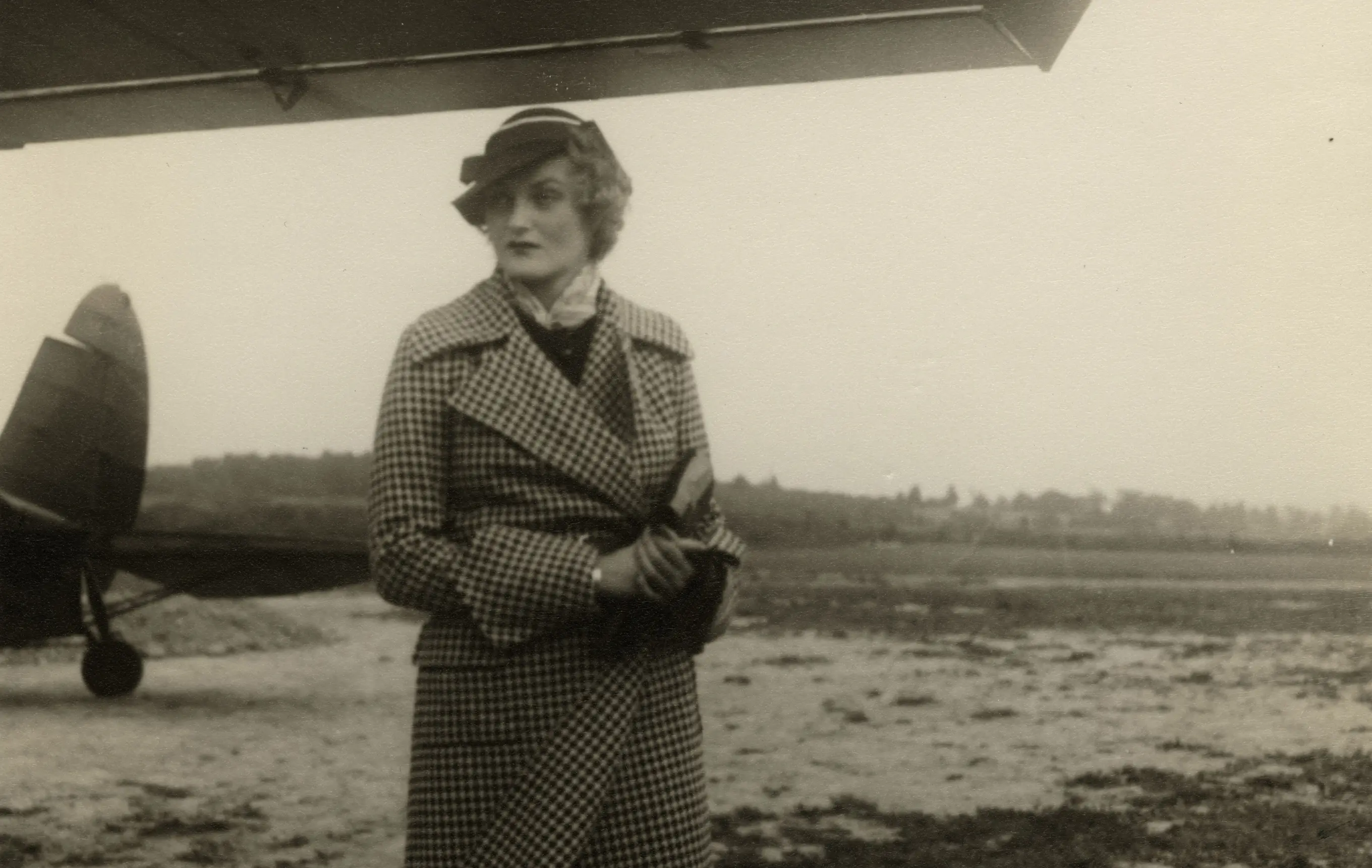 Doris Duke standing in front of a plane