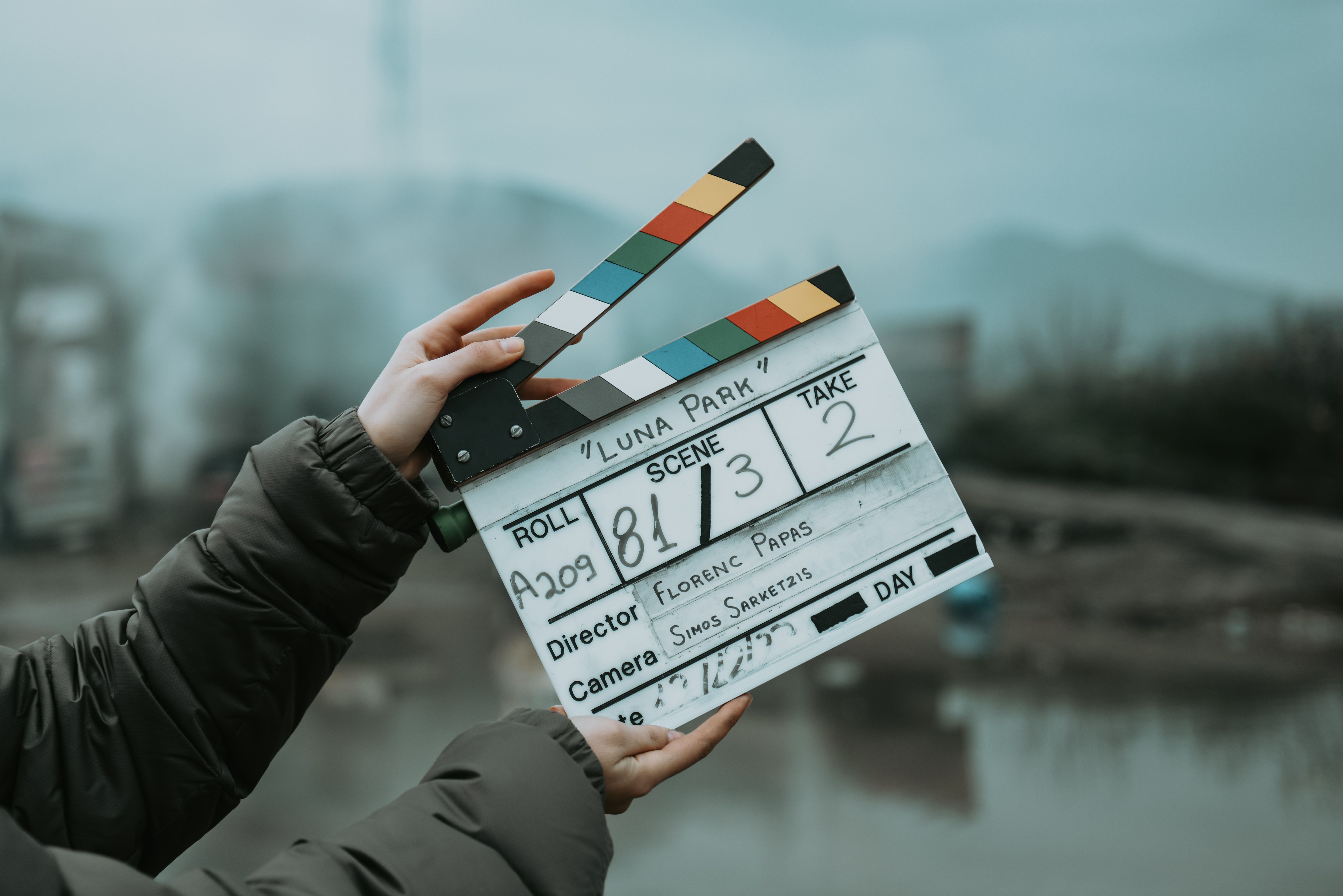 Close-up of a film clapperboard on an outdoor set, signaling scene start
