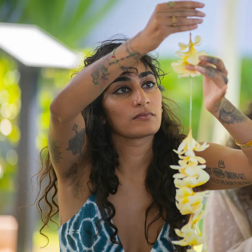 Two women making a lei
