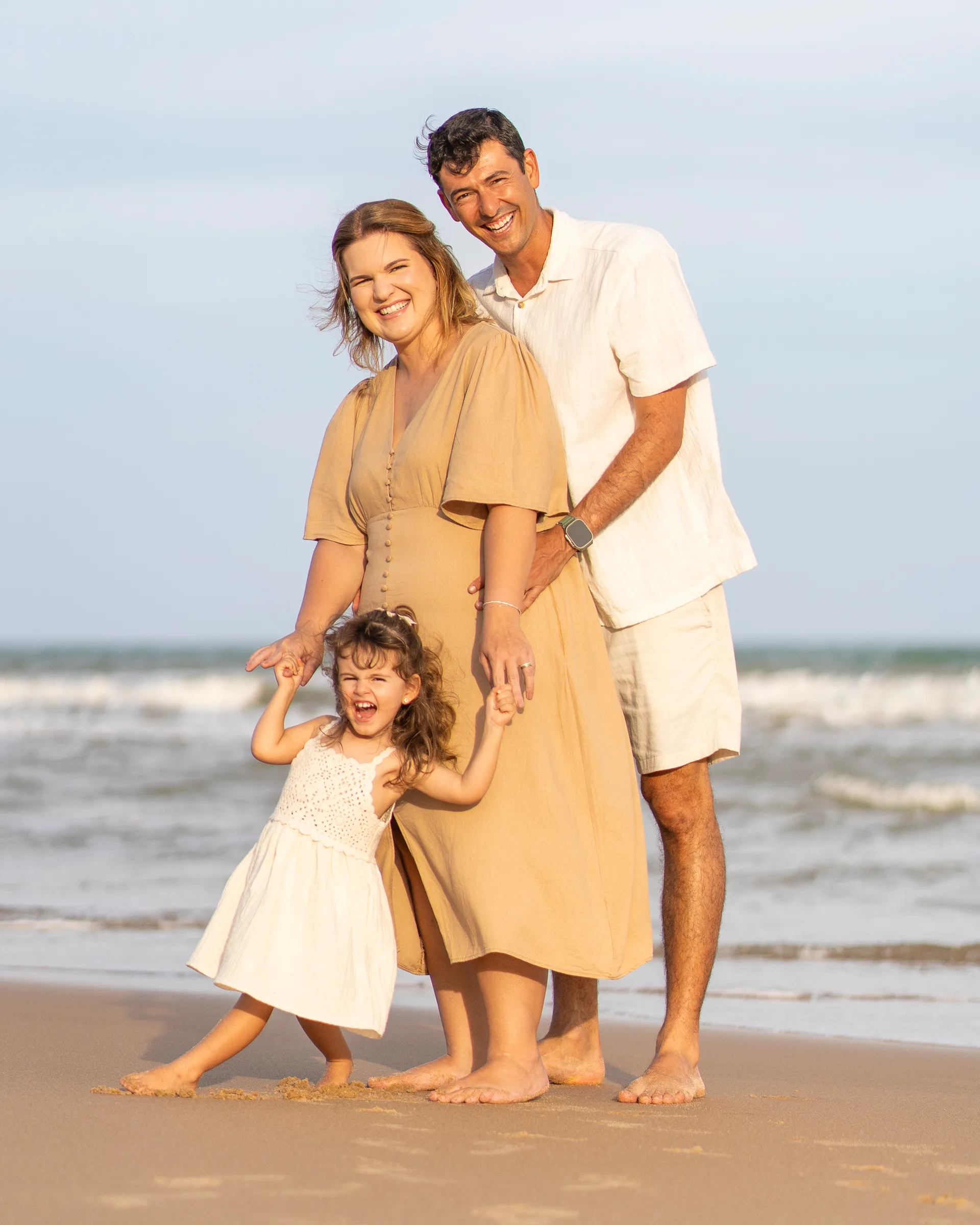 Happy family enjoying themselves by the beach