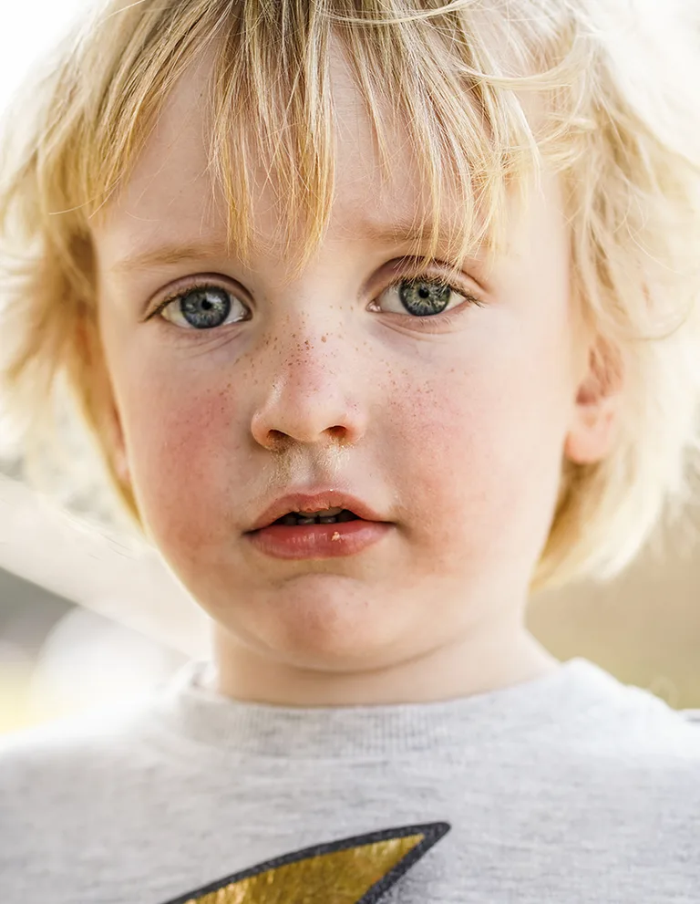 A close portrait of a young child in soft natural light