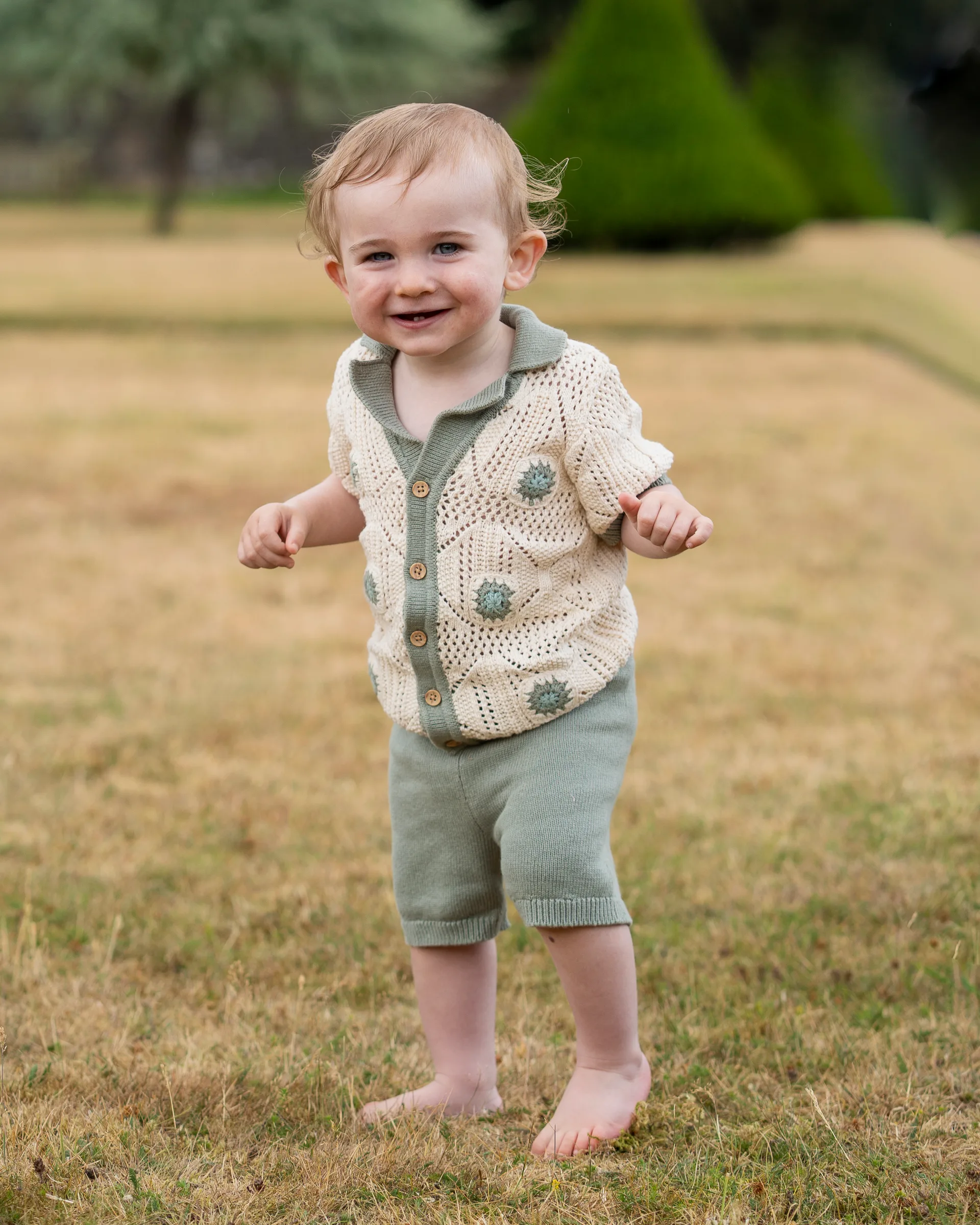 Cute little boy playing outside of the garden