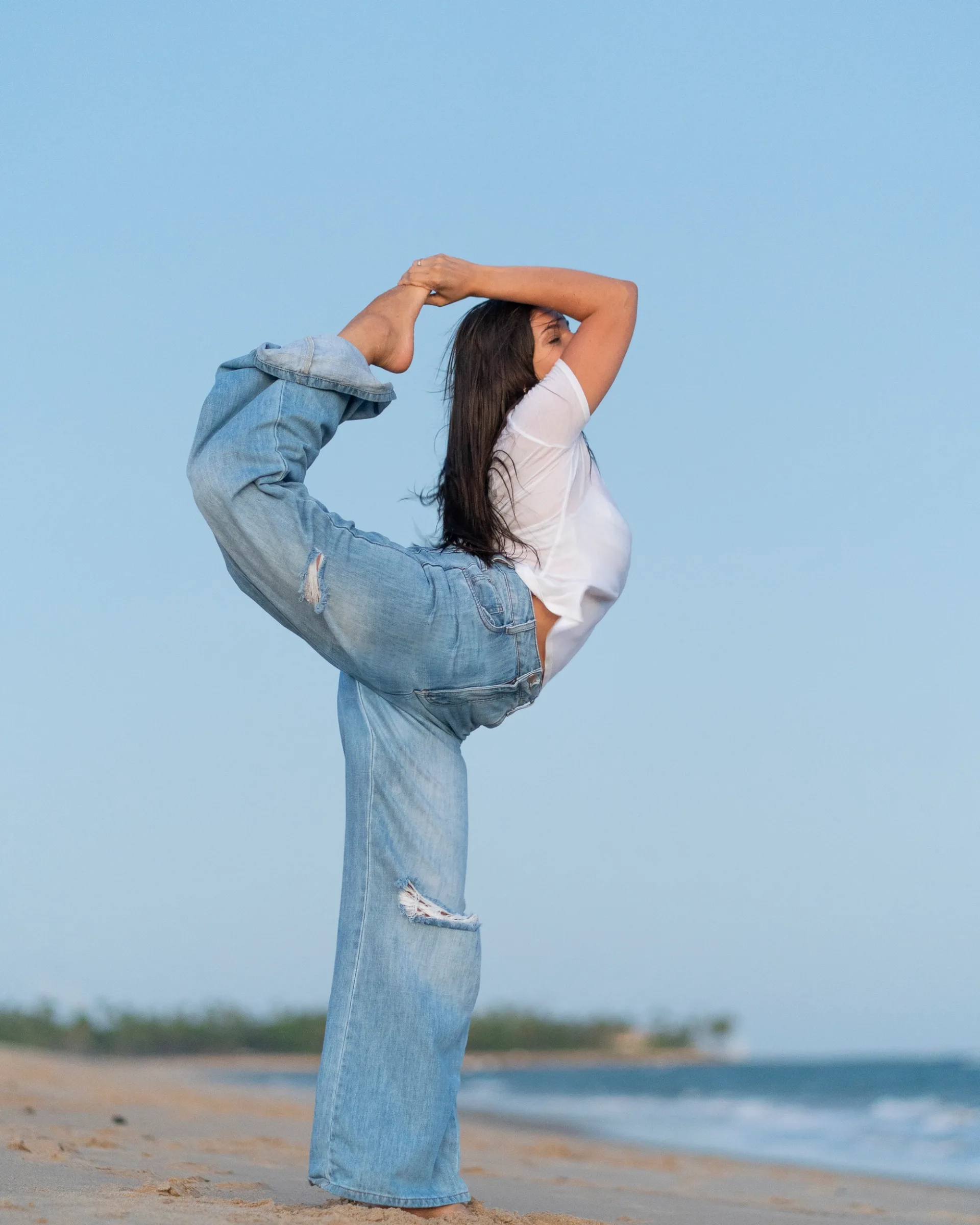 yoga portrait on the beach, capturing strength, balance and fluid movement against the ocean backdrop.