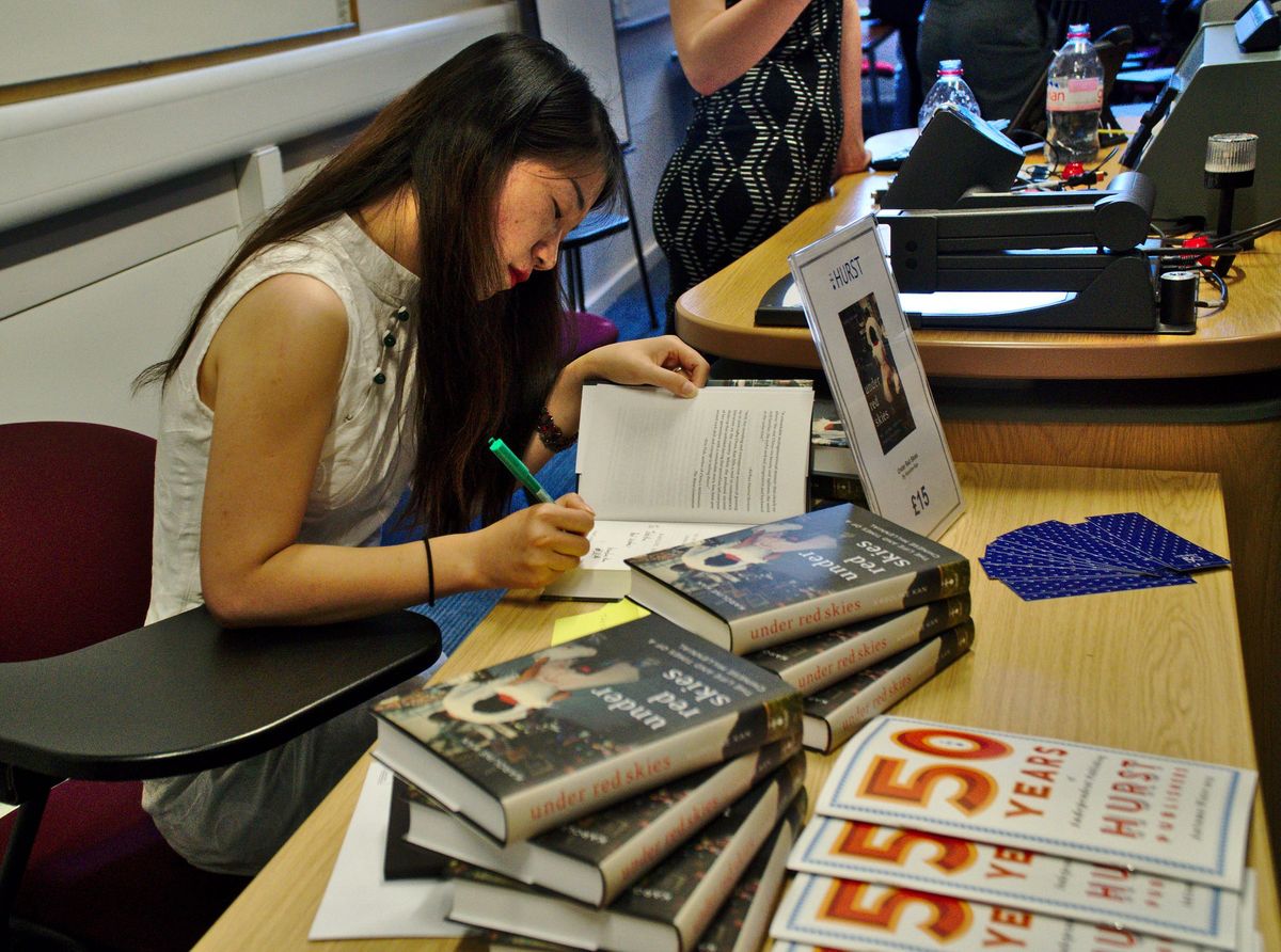 Karoline Kan signing books.  Photo Credit: Danny Vegel.