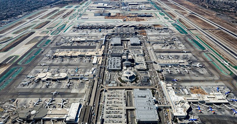 Los Angeles LAX airport aerial — India to USA cheapest month October November 2026 connecting flight via Gulf hub.