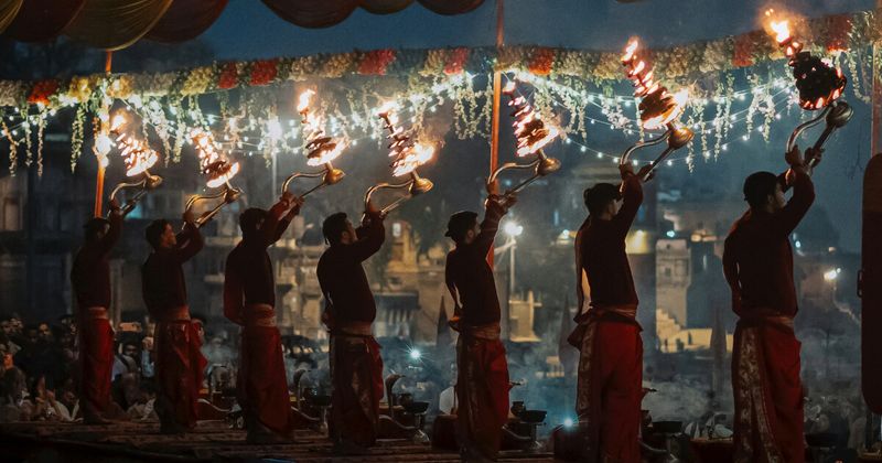 Ganga Aarti at Dashashwamedh Ghat in Varanasi — the seven-priest synchronized fire ceremony begins at 6:45pm in summer and 5:45pm in winter; free from the steps, or viewable from a private boat from ₹1,299 per boat; the ceremony runs nightly 365 days a year without exception