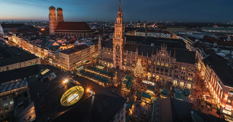 Cheapest flights India to Germany 2026 — Munich Marienplatz aerial night for Indian travellers Frankfurt vs Munich entry comparison.