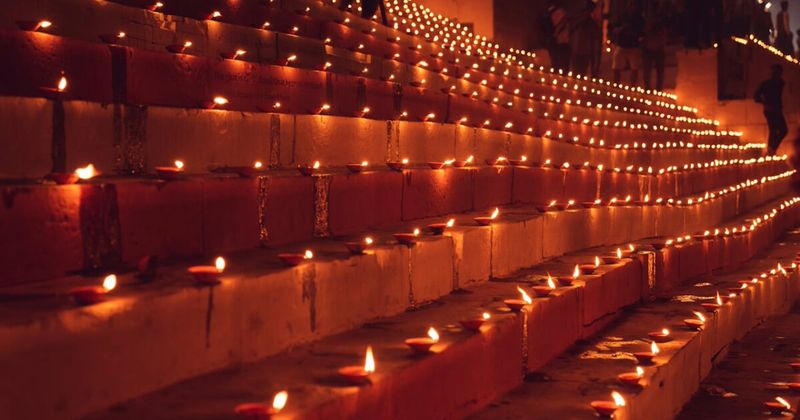 Dev Diwali at Varanasi — all 84 ghats are illuminated with millions of clay diyas on Kartik Purnima (November 5, 2026); the reflection in the Ganga of a continuous ribbon of firelight along 6.5 kilometres of river steps is the most visually extraordinary festival night in India; pre-book river boats by August