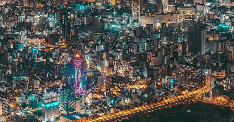 Osaka aerial city view at night — Japan to India flights KIX Kansai International Osaka 2026.