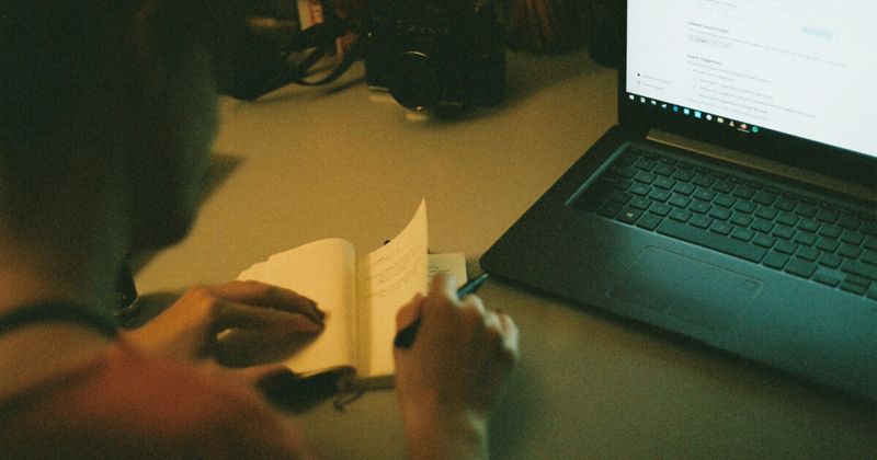  Person planning USA to India flight booking windows by month at desk — 2026 guide