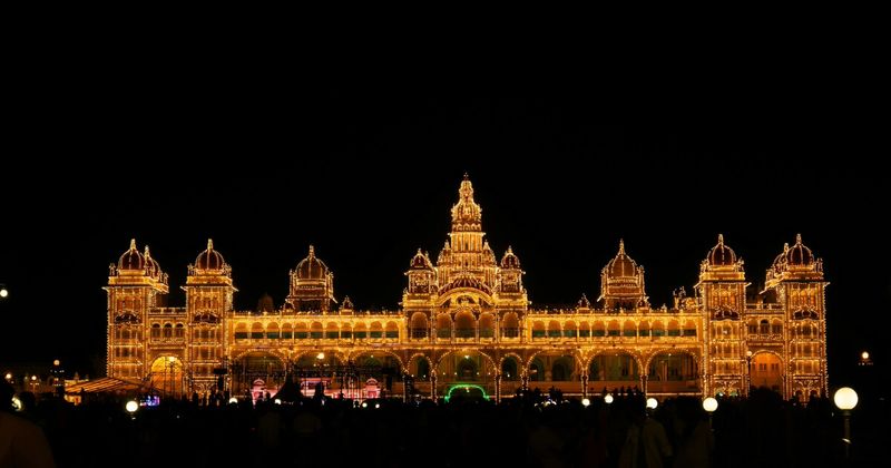 Mysore Palace illuminated with 100,000 bulbs every Sunday 7–8pm — free to watch from outside; entry ₹200 foreigners by day.