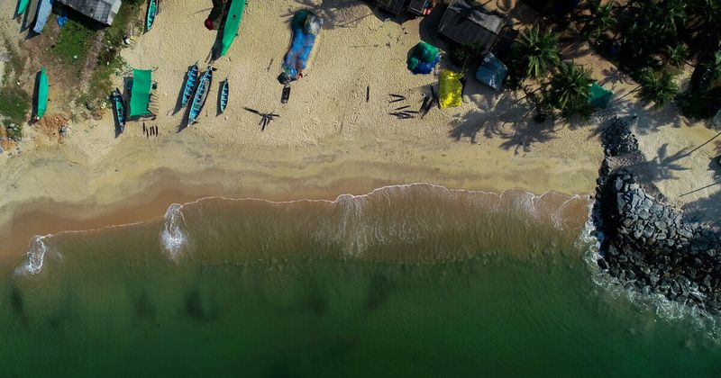Maravanthe Beach, Karnataka — NH66 runs between the Arabian Sea and Souparnika River; at the narrowest point the beach is under 100m wide; stop at the elevated pullout 1km north.
