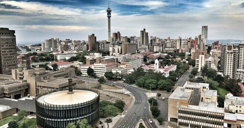 Johannesburg city skyline golden hour — cheapest hub strategy South Africa to India flights 2026.