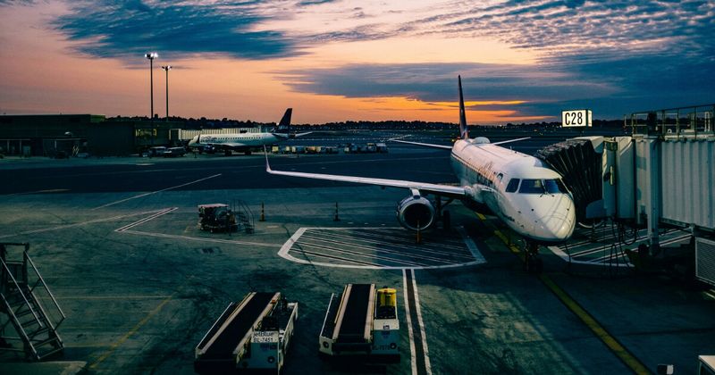 Multiple airline aircraft at international terminal — LAX to India airlines comparison 2026