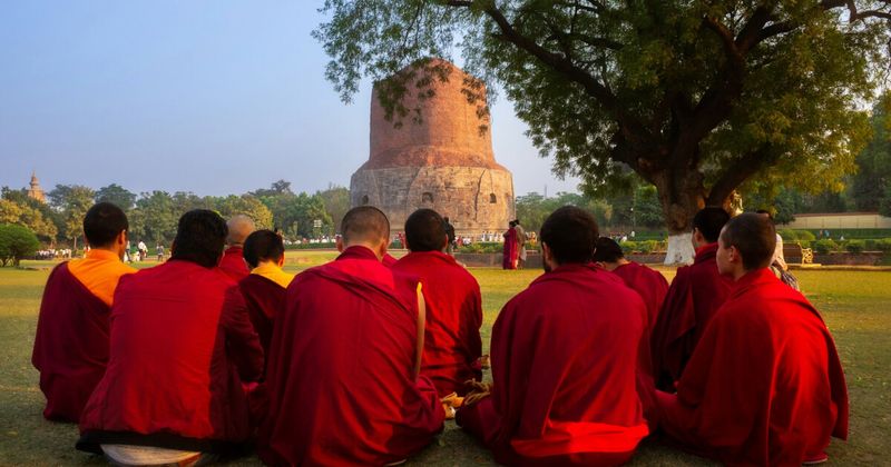 The Dhamek Stupa at Sarnath, 10 kilometres from Varanasi — built in 500 CE to mark the spot where the Buddha delivered his first sermon in 528 BCE; entry ₹25 per person (Indian nationals); the Sarnath Archaeological Museum adjacent contains the original 2,300-year-old Ashoka Lion Capital that became independent India's national emblem