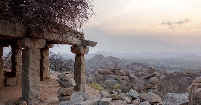 The view from Matanga Hill at sunset in Hampi — the highest accessible point in the Hampi valley shows the full scope of the UNESCO site: the Virupaksha Temple, the Tungabhadra, and the extraordinary granite boulder landscape that predates human civilisation by 2.5 billion years; free entry, 20–30 minute climb