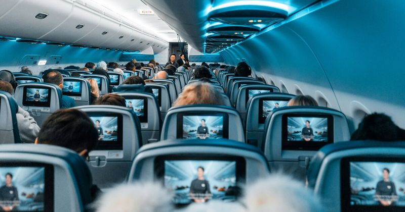 Aircraft economy cabin with personal screens — Air India new fleet economy review London to India 2026