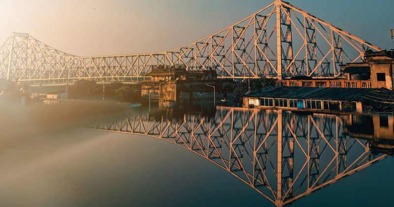 Howrah Bridge at dawn, Kolkata — the world's busiest bridge by foot traffic; 100,000 vehicles and 150,000 pedestrians daily; free; best at 5:30am.