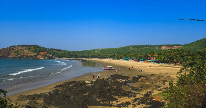 Om Beach, Gokarna — naturally shaped like the Aum symbol when viewed from above; 20-minute walk from Gokarna town; Namaste Café for sunset views.