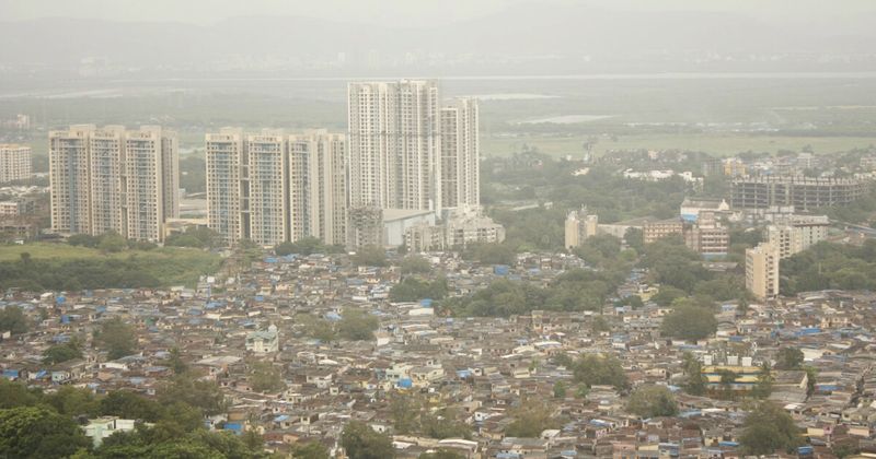 Dharavi from above — the 2.4-square-kilometre settlement in central Mumbai generates an estimated $1–1.5 billion annually through 20,000+ micro-enterprises; processes 80% of Mumbai's plastic waste; ethical guided tours from ₹500 per person via Klook with resident guides