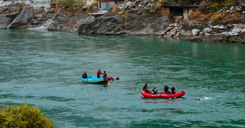 Rafting team paddling through rapids on the Ganges River Rishikesh