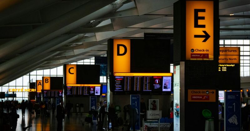 Traveller at Heathrow departure gate — Air India British Airways Virgin Atlantic London to India 2026
