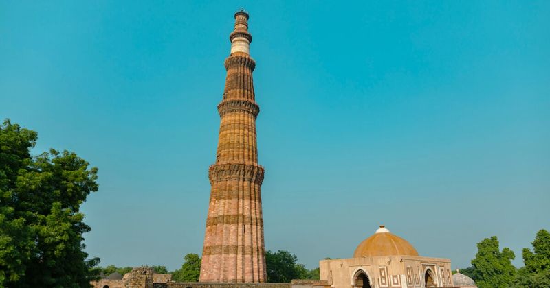 Qutub Minar in South Delhi — the world's tallest brick minaret at 73 metres, built in 1193 by Qutb-ud-din Aibak as the founding monument of the Delhi Sultanate; foreigner entry ₹550–₹600, the complex also contains the 5th-century Iron Pillar that has not rusted in 1,600 years