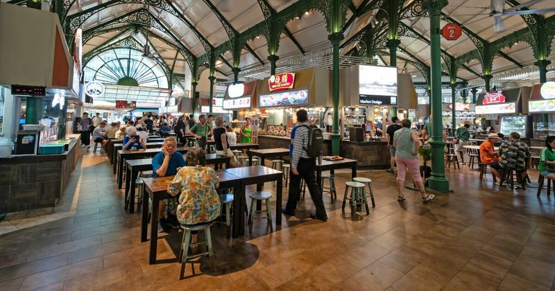Singapore Maxwell Food Centre hawker stalls at night — accessible from Mumbai on flights from ₹20,210 return September 2026.