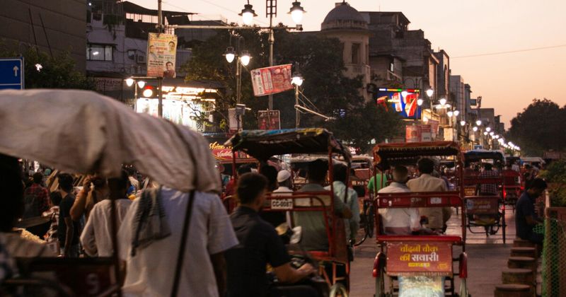 Chandni Chowk market lane in Old Delhi at dusk — the 17th-century Mughal market district runs from the Red Fort gate to Fatehpuri Mosque and is the most concentrated street food and spice market experience in North India