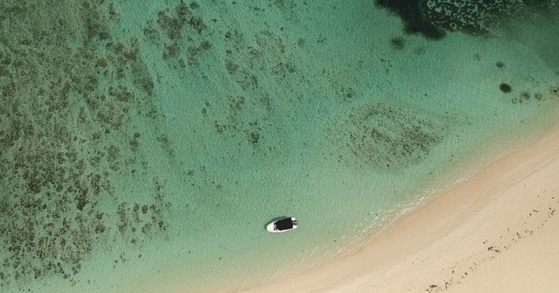 Mauritius beach aerial view — 90-day visa-free for Indian passport holders return flights from ₹28,000.