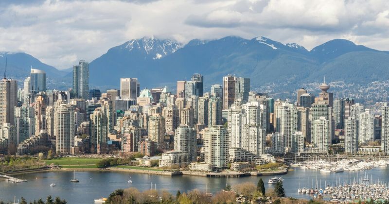 Vancouver skyline with mountains — cheapest flights Vancouver to India 2026 Pacific hub routing advantage