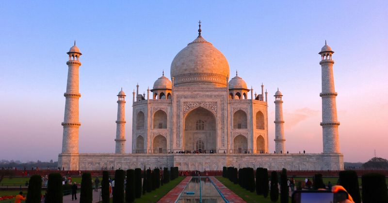 The Taj Mahal at dawn in Agra — the Mughal mausoleum built 1632–1653 by Emperor Shah Jahan is best experienced before 8am when the garden is empty; foreigners ₹1,100 entry + ₹200 mausoleum = ₹1,300 total; closed Fridays