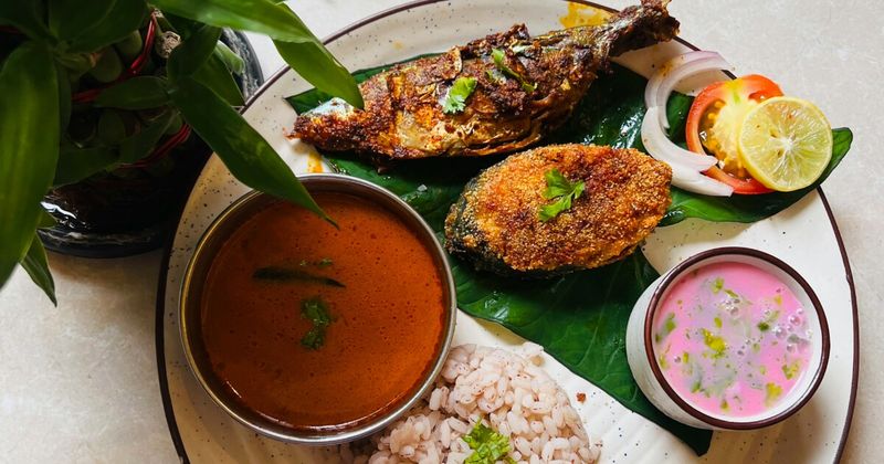 Mangalorean fish curry with Byadgi chilli and kudampuli — the defining dish of Tulu Nadu coastal Karnataka; ₹150–250 at neighbourhood restaurants.