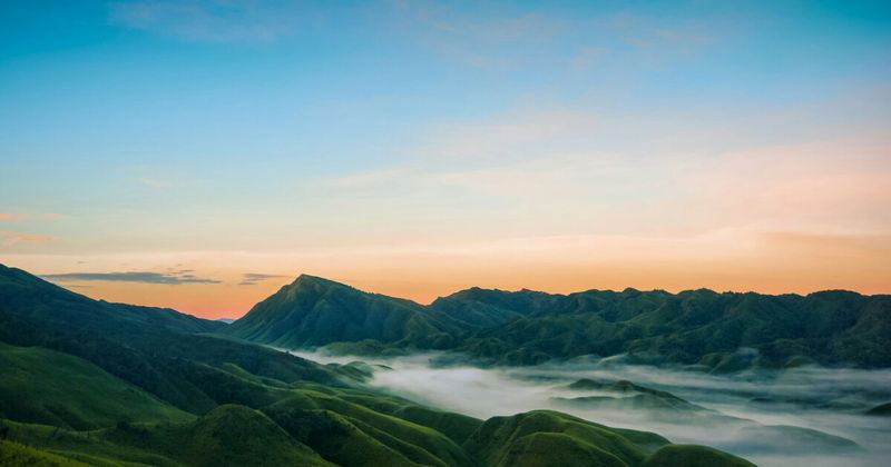 Misty dawn valleys of Northeast India rolling jungle hills — Northeast India itinerary for foreign tourists