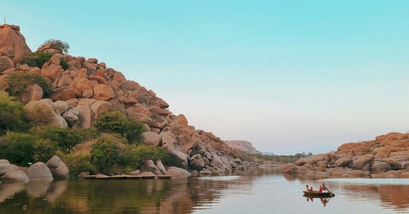 A coracle on the Tungabhadra river at Hampi — the circular bamboo boat is the traditional river crossing between Hampi village and the northern bank; ₹30 per person; the 10–15 minute crossing provides the most complete view of the Hampi riverscape from water level