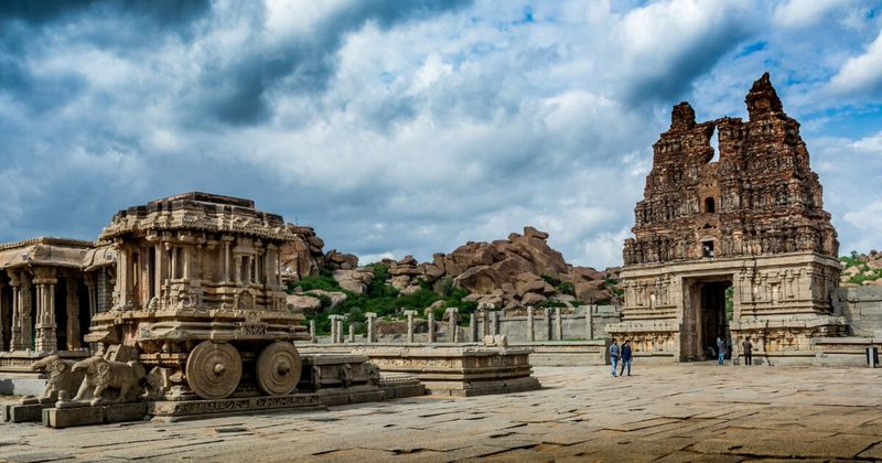 The Stone Chariot at Vittala Temple in Hampi — a 16th-century granite shrine in the form of Garuda's chariot, built during Krishnadevaraya's reign; the stone wheels were originally capable of rotating; foreigners ₹500; best photographed at 3–4pm in afternoon light