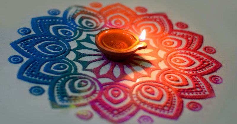  Rangoli at a doorstep during Diwali in India — the geometric floor art uses natural pigments and is traditionally believed to welcome Goddess Lakshmi into the home; designs are created on Diwali morning and erased by foot traffic within 24 hours; Diwali 2026 is October 20