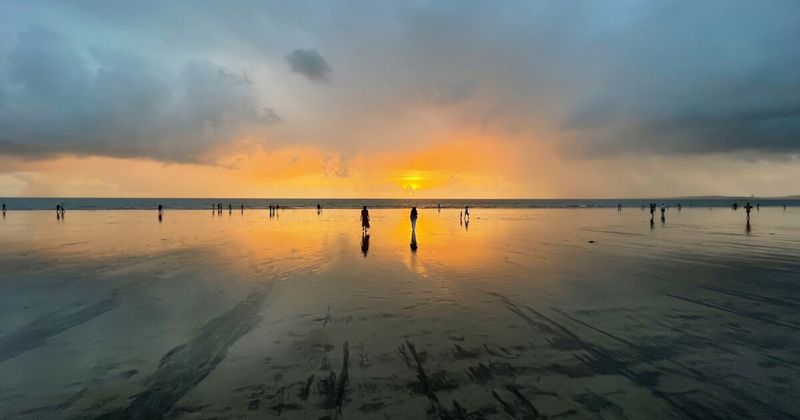 Juhu Beach at sunset in Mumbai — the 6-kilometre beach in the northern suburb is Mumbai's most democratic public space at evening; street food stalls serve vada pav (₹20–40), pav bhaji (₹80–150), and bhel puri (₹30–50); the sunset over the Arabian Sea is one of the best in the city