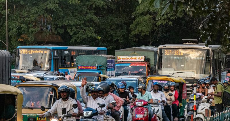 Traffic jam in India with buses and rickshaws.