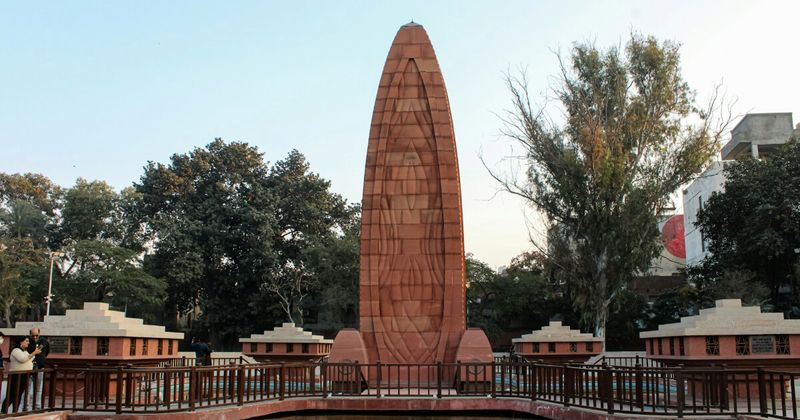 Jallianwala Bagh in Amritsar — the bullet holes from General Dyer's April 13, 1919 massacre remain in the brick walls; the official British count was 379 dead; Indian investigations estimated over 1,000; the narrow entrance where soldiers stood is unchanged from 1919; free entry