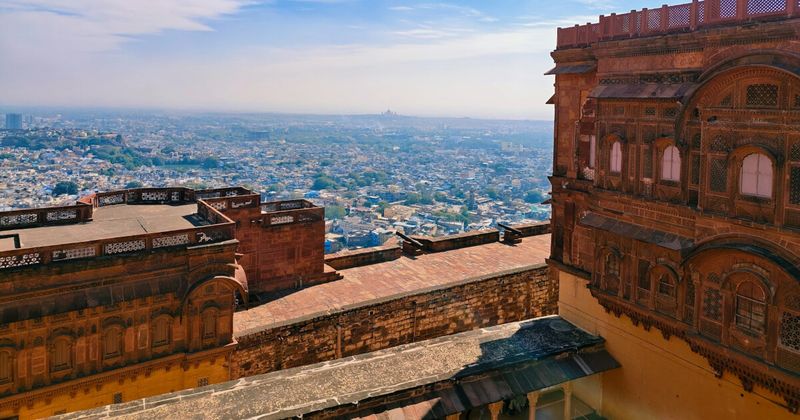 View from Mehrangarh Fort ramparts over Jodhpur's blue-washed old city — the Brahmin quarter's blue paint was originally applied with lime to repel insects; ₹800 foreign entry includes the audio guide which narrates the seven-gate approach to the fort