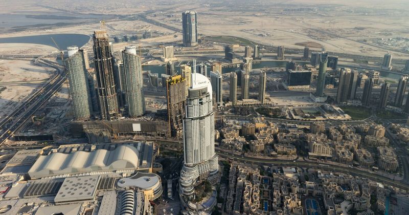 UAE aerial view — Sharjah vs Dubai airport comparison for India flights 2026.