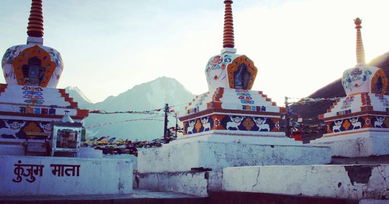 Prayer flags at Kunzum Pass (4,590m) — the pass connecting Spiti Valley to Lahaul and the Manali exit; open June–October; may close without notice.
