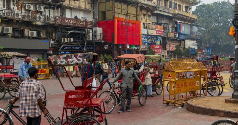 Crowded Old Delhi bazaar lane with shoppers and market stalls — 2 weeks in India itinerary Delhi