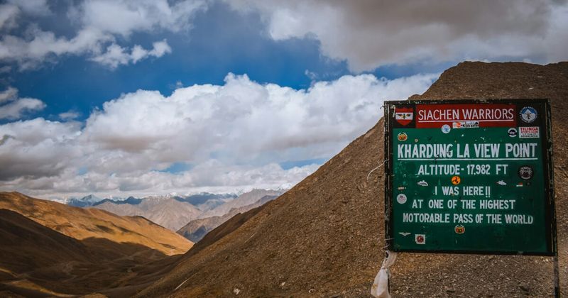 Khardung La Pass at 5,359 metres on the road from Leh to Nubra Valley — the pass crosses the Ladakh range and offers a panorama of the Karakoram to the north; spend a maximum of 20 minutes at the summit to avoid altitude effects