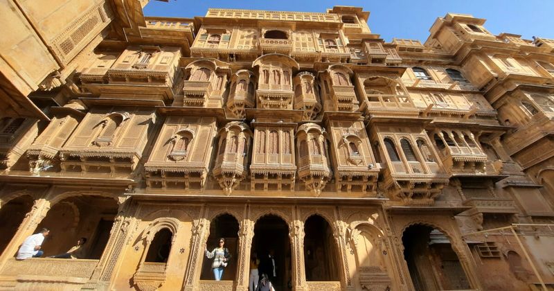 A Jaisalmer haveli facade — the 19th-century merchant mansions of Jaisalmer feature sandstone carved to a delicacy that rivals any stone carving in India; the Patwon ki Haveli (five connected mansions) represents the peak of this tradition, built by the Patwa merchant family over 55 years from 1800 to 1855