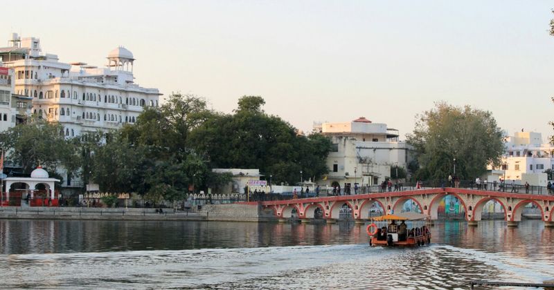 Gangaur Ghat in Udaipur at golden hour — the most atmospheric lakefront stretch in the city, where whitewashed buildings reflect in Lake Pichola; the light between 5pm and 6:30pm is the best 90 minutes of Udaipur's day and doesn't require a ticket, a boat, or a reservation