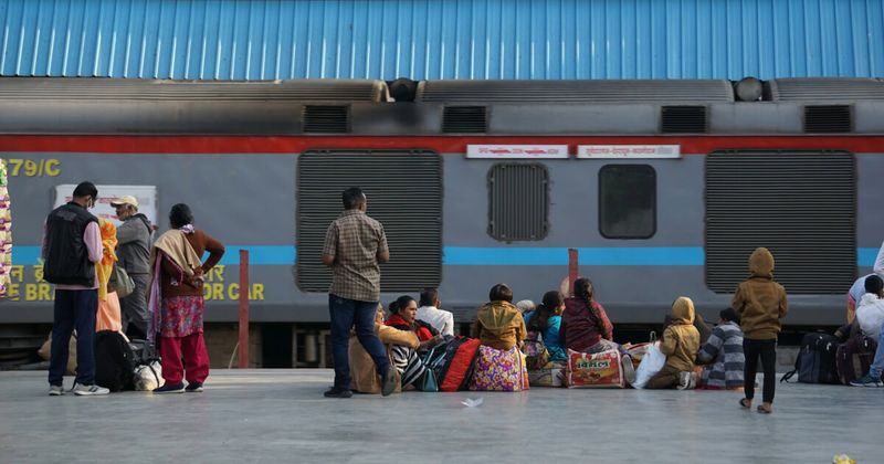 Passengers and luggage on an Indian railway platform — booking Mumbai to Goa train tickets 60 days ahead on 12Go Asia gets the best availability and base fares from ₹490 Sleeper class