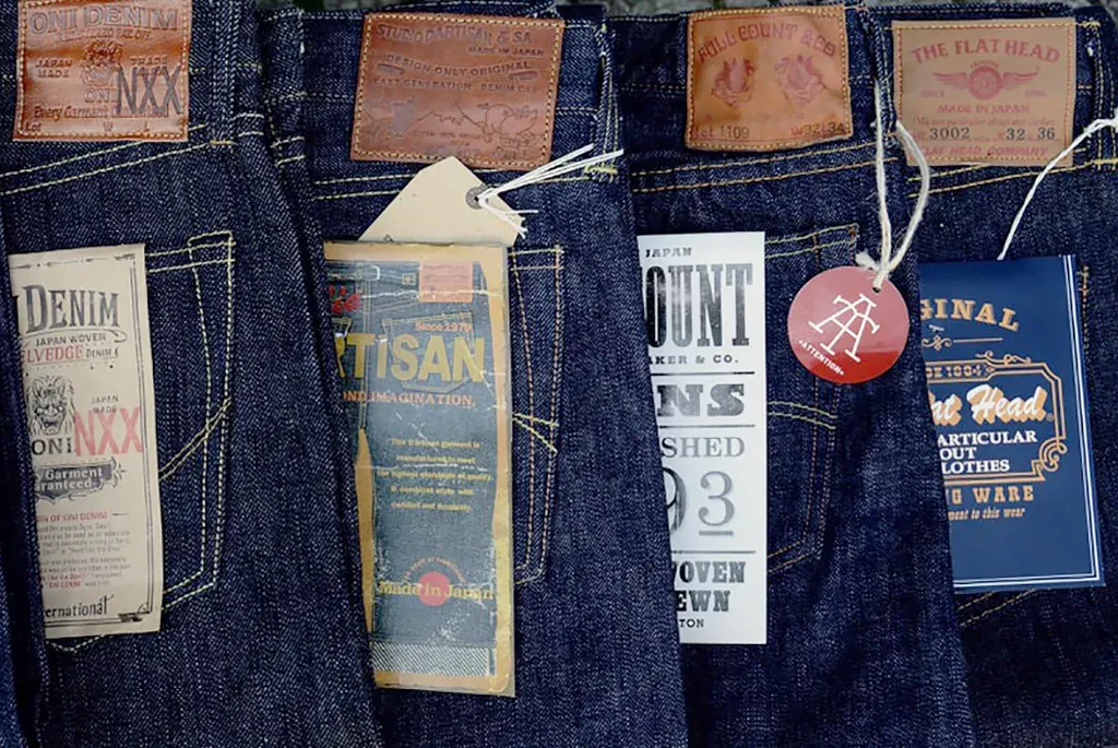 Japanese selvedge denim collection with leather patches and branded tags from ONI, The Flathead, and other premium manufacturers.